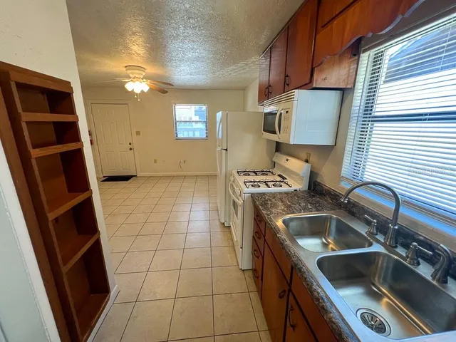 a kitchen that has a sink and a stove