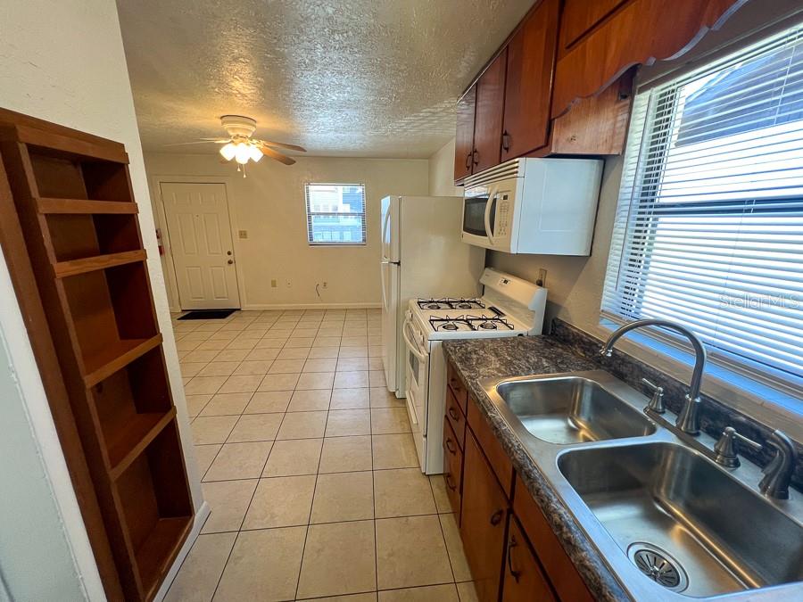 1406 Southwest 18th Place, Unit 4 Gainesville, FL 32608 - Photo 6 of 16 a kitchen that has a sink and a stove