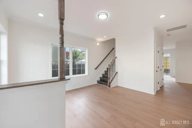 a view of an entryway with wooden floor