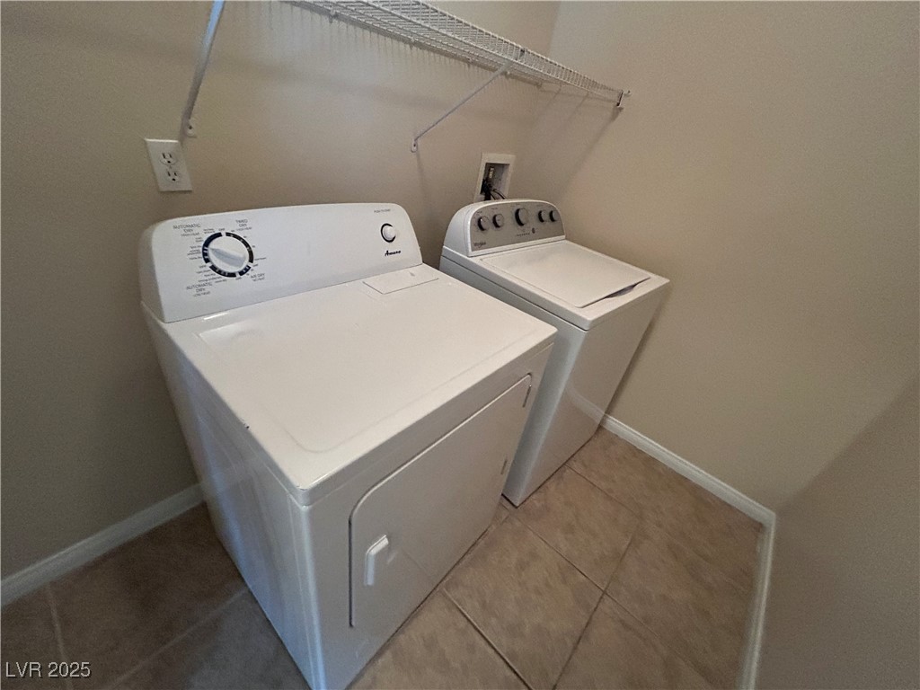 9303 Gilcrease Avenue, Unit 1131 Las Vegas, NV 89149 - Photo 9 of 36 Washroom featuring light tile patterned flooring and washer and dryer