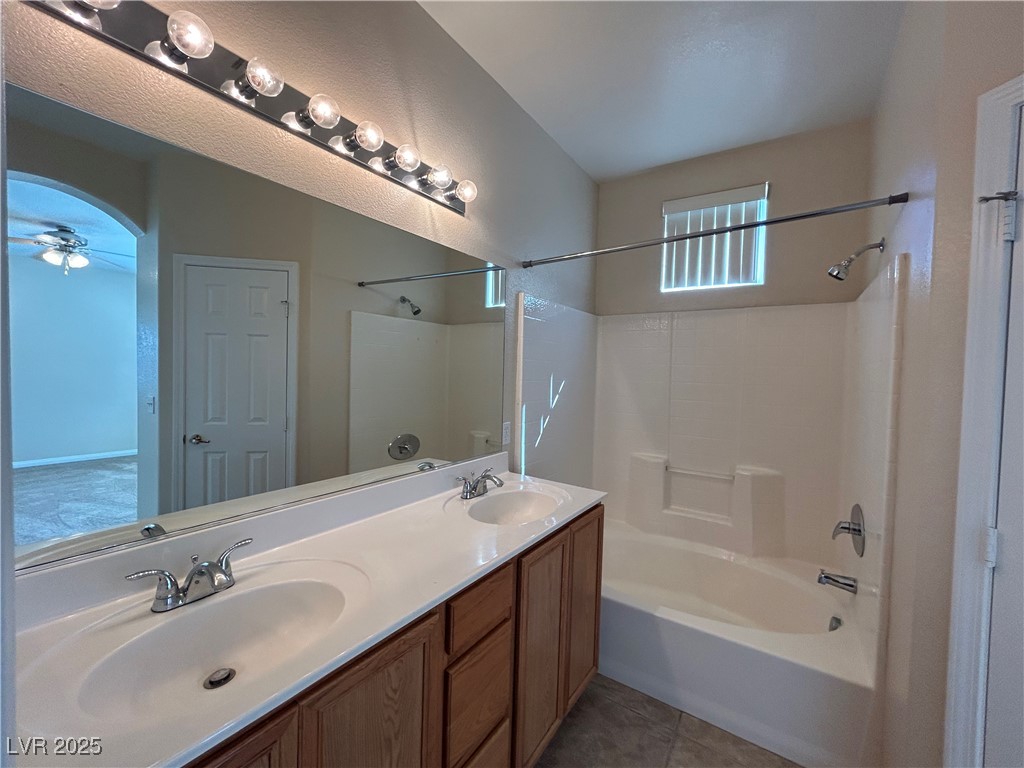 9303 Gilcrease Avenue, Unit 1131 Las Vegas, NV 89149 - Photo 15 of 36 Bathroom featuring bathtub / shower combination, double vanity, and light tile patterned floors
