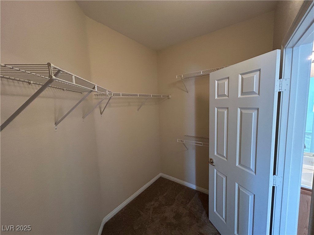9303 Gilcrease Avenue, Unit 1131 Las Vegas, NV 89149 - Photo 16 of 36 Spacious closet featuring dark colored carpet