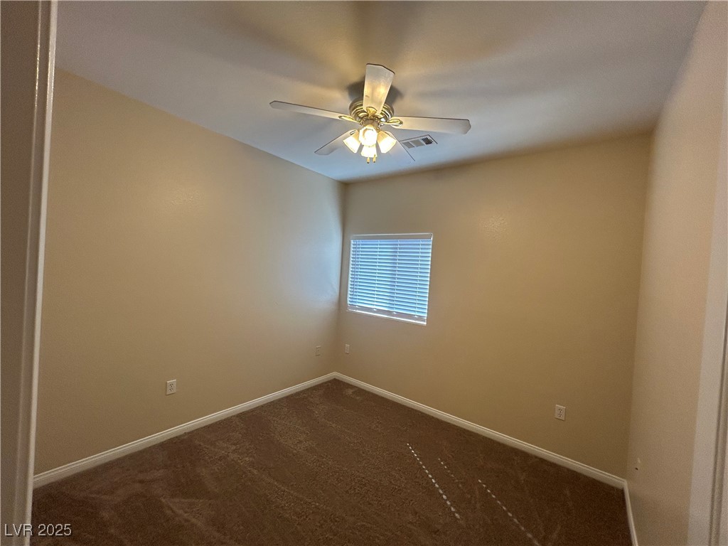 9303 Gilcrease Avenue, Unit 1131 Las Vegas, NV 89149 - Photo 19 of 36 Unfurnished room with dark carpet and ceiling fan