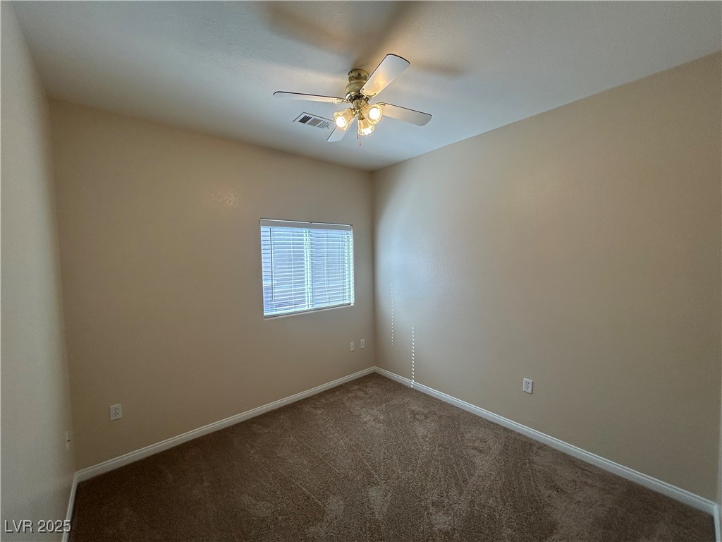 9303 Gilcrease Avenue, Unit 1131 Las Vegas, NV 89149 - Photo 22 of 36 Empty room featuring carpet flooring and ceiling fan