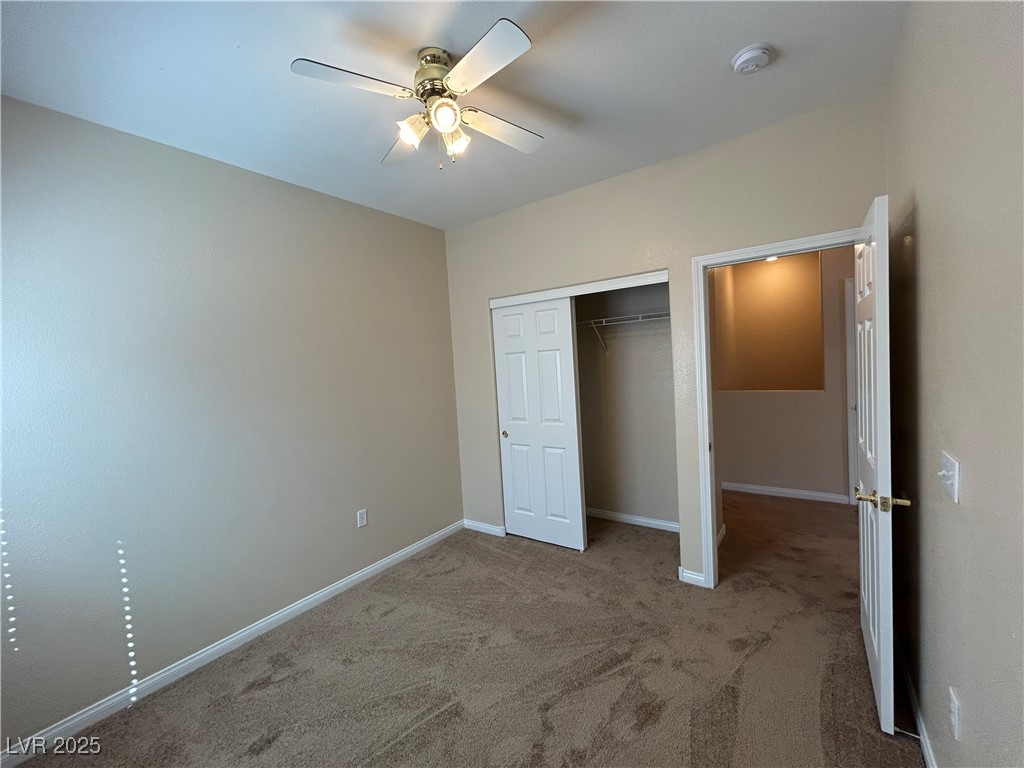 9303 Gilcrease Avenue, Unit 1131 Las Vegas, NV 89149 - Photo 23 of 36 Unfurnished bedroom featuring carpet flooring, a closet, and ceiling fan