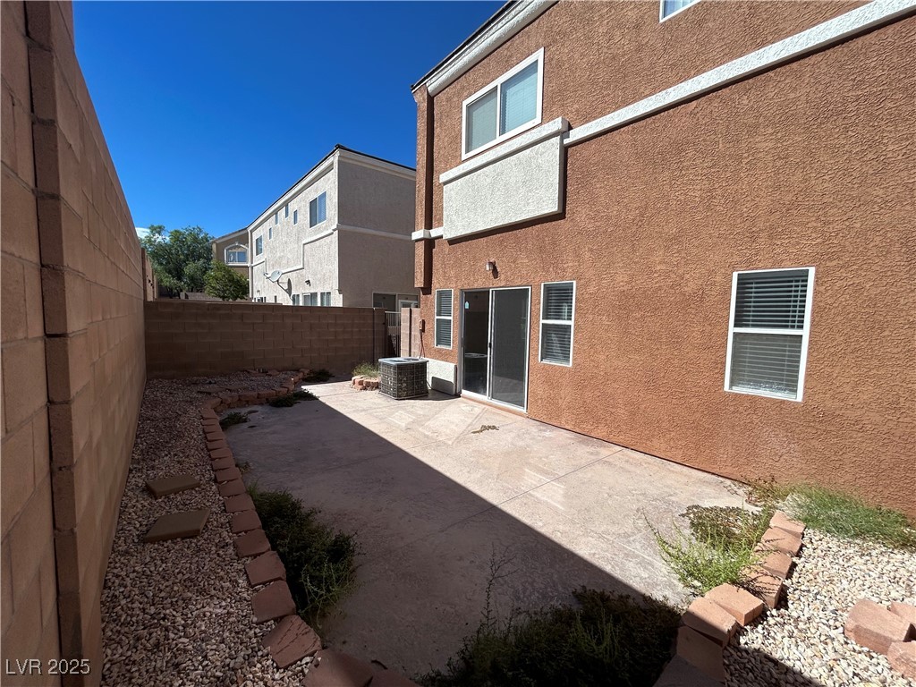 9303 Gilcrease Avenue, Unit 1131 Las Vegas, NV 89149 - Photo 31 of 36 Rear view of house featuring a patio area, stucco siding, and a fenced backyard