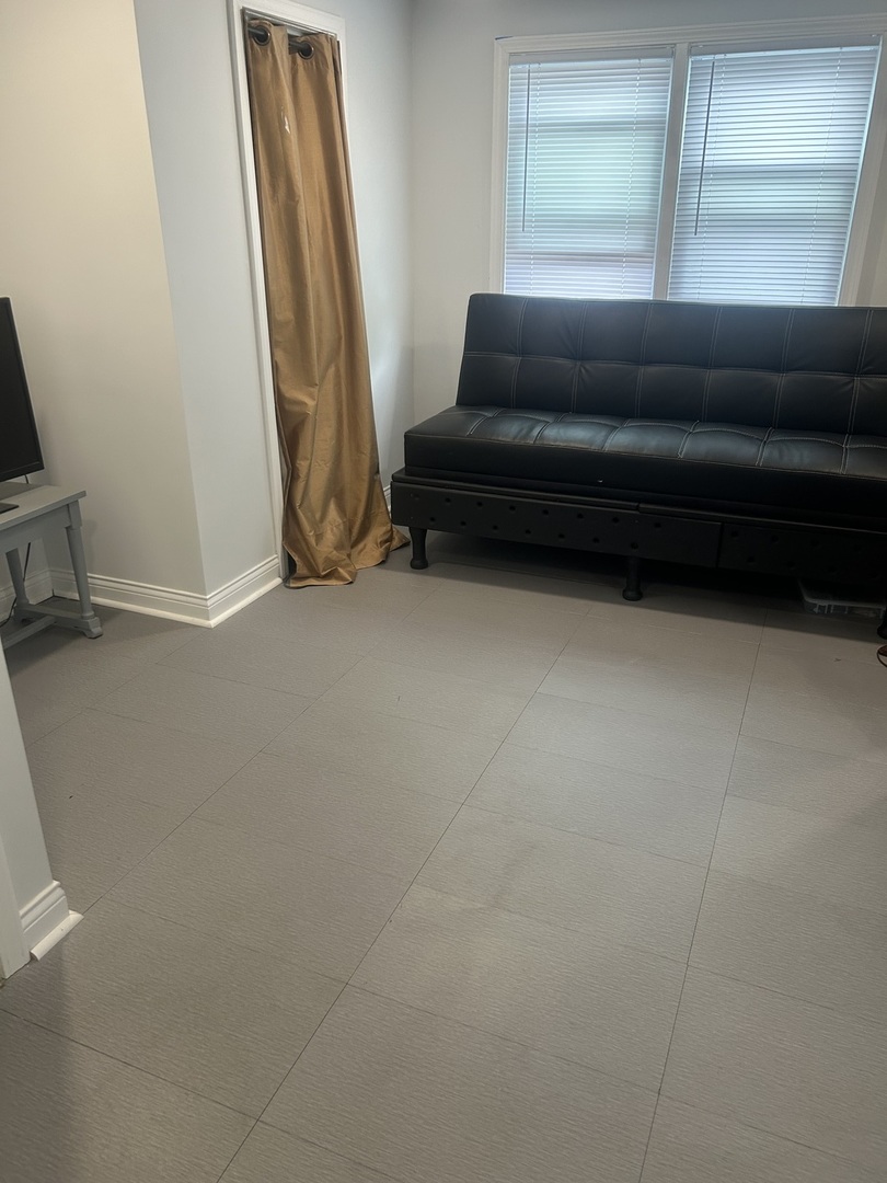 2816 West 85th Street Chicago, IL 60652 - Photo 11 of 22 a living room with a couch and a walk in closet