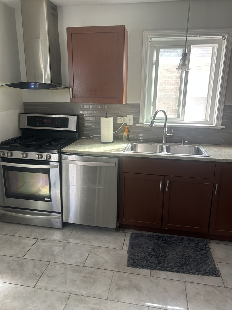2816 West 85th Street Chicago, IL 60652 - Photo 8 of 22 a kitchen with stainless steel appliances a sink stove and cabinets