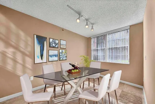 a view of a dining room with furniture and window