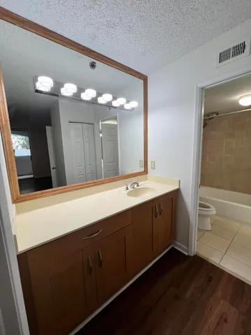 a bathroom with a double vanity sink and a mirror