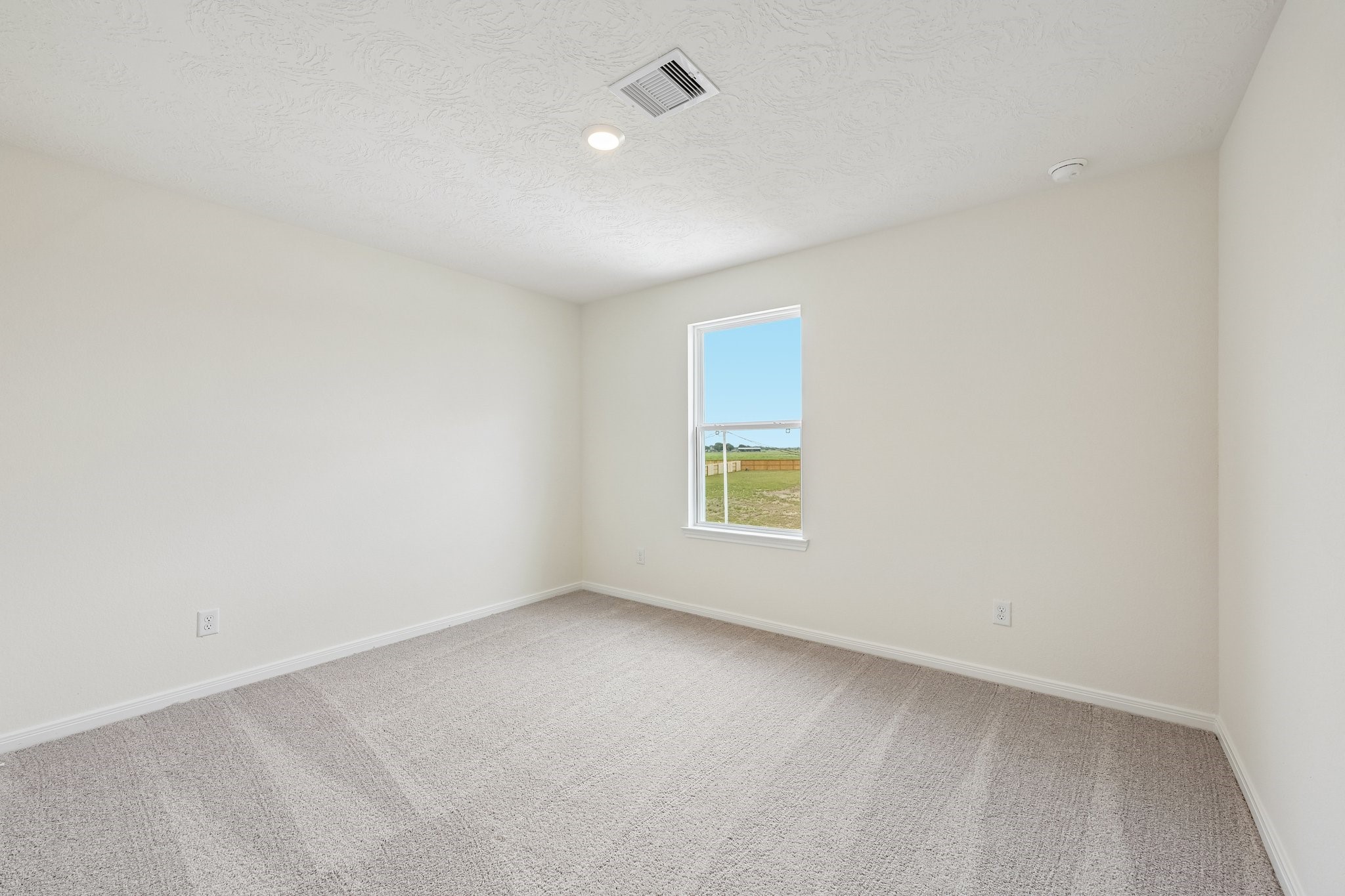 2503 Spruce Hl Road Beasley, TX 77417 - Photo 18 of 25 This secondary bedroom offers comfort and style with plush carpeting, neutral paint tones, recessed lighting, large window, and a generously sized closet.