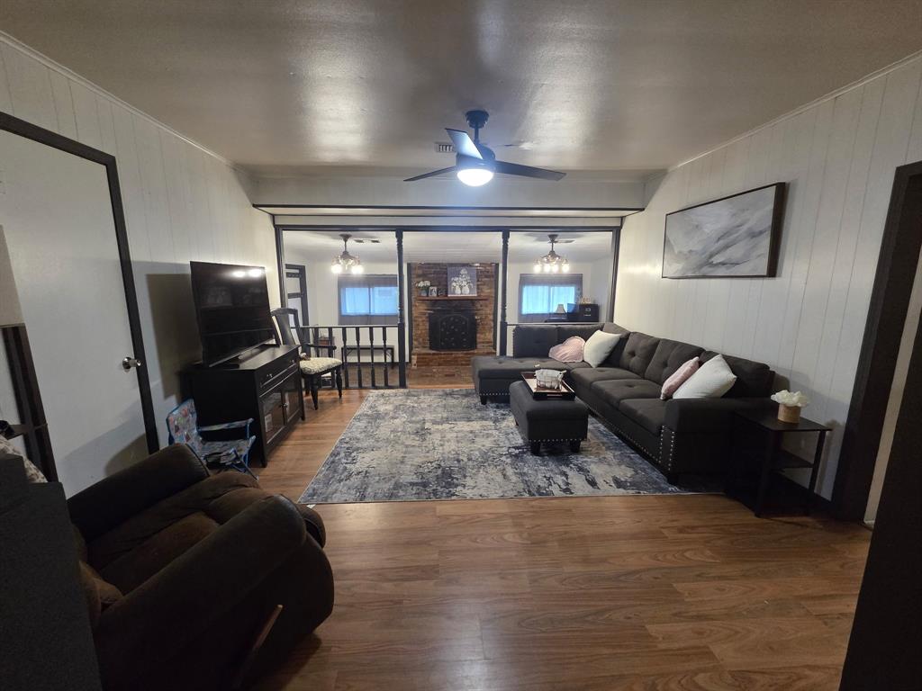 301 Old Plain Dealing Road Benton, LA 71006 - Photo 4 of 19 Warm wood-finish flooring complements white vertical paneling in this living area