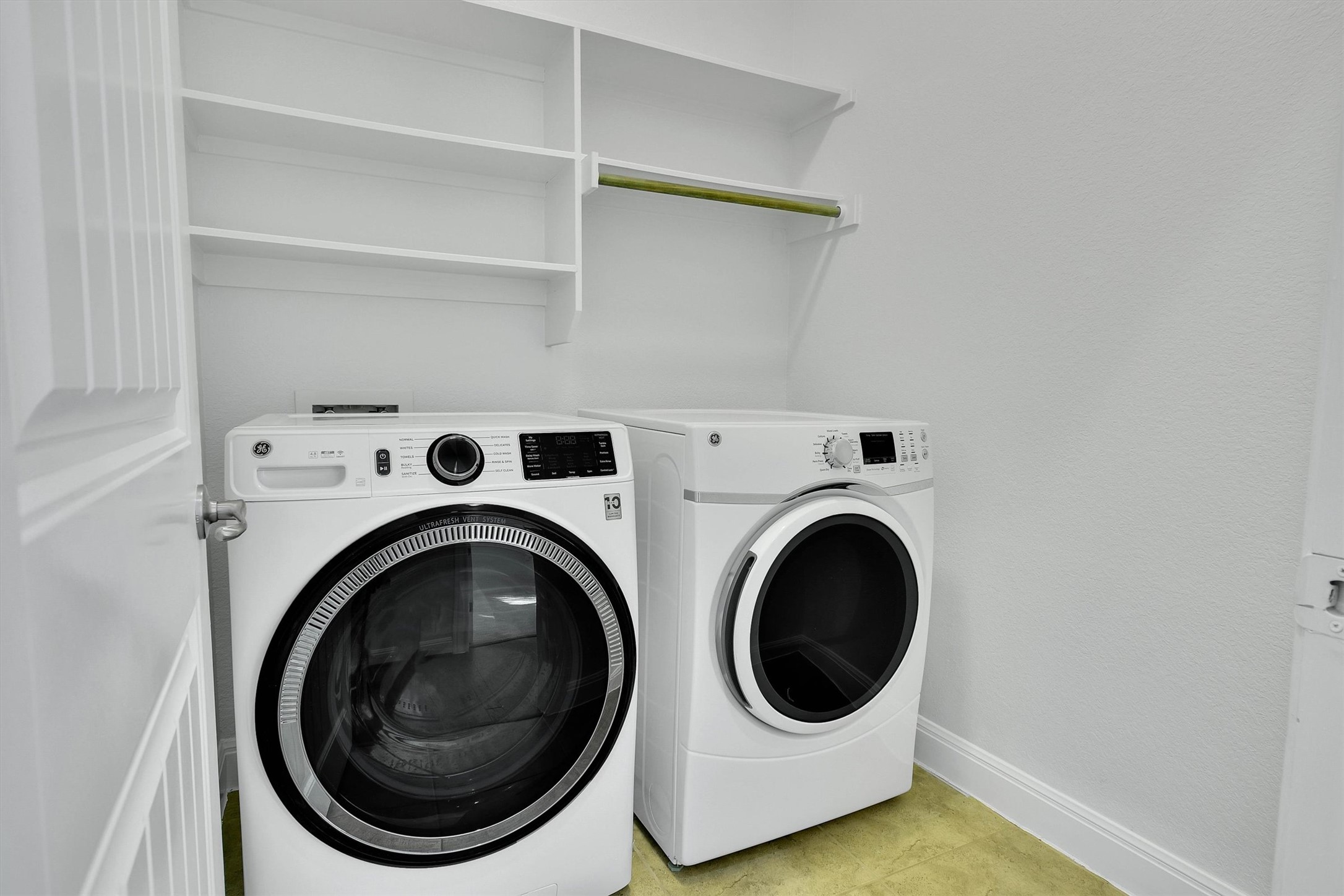 2325 Blended Tree Ranch Drive Leander, TX 78641 - Photo 33 of 35 A dedicated laundry space featuring a washer and dryer, complete with convenient shelving and a hanging rod.