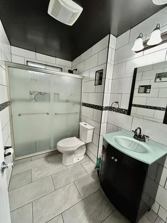 a bathroom with a sink toilet and shower