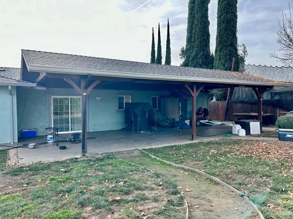 a view of a house with a porch and furniture