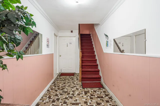 a view of a hallway with wooden floor and stairs