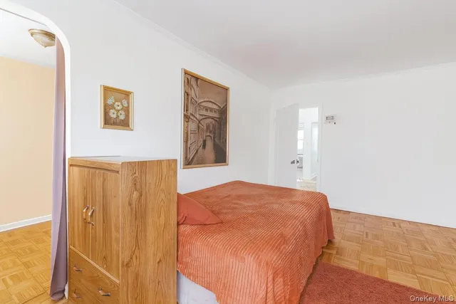 a bedroom with a bed and painting on the wall