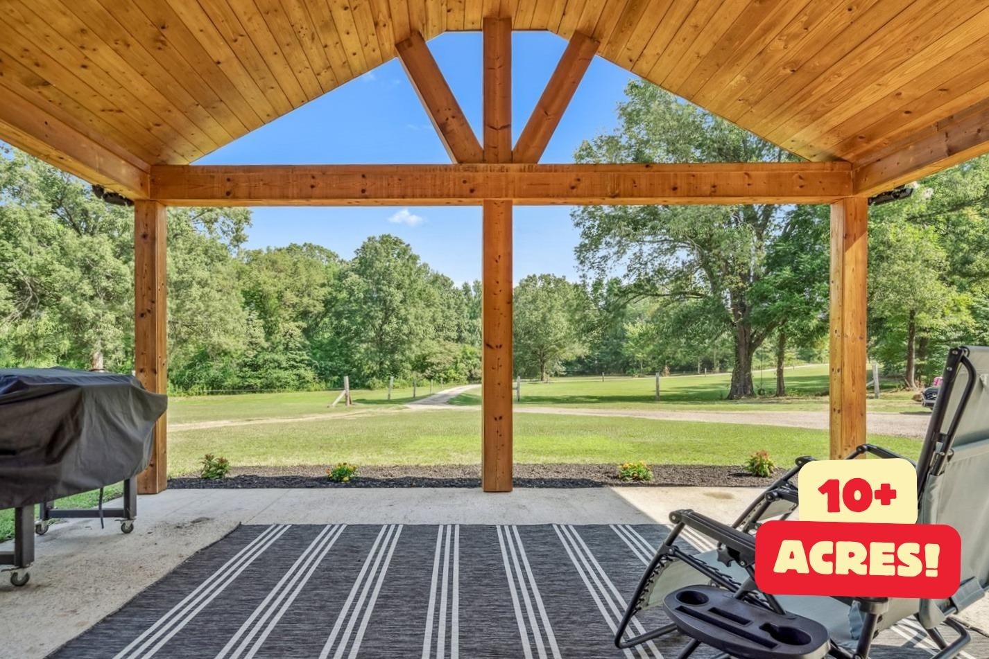 a view of a chairs and table in the patio with a yard