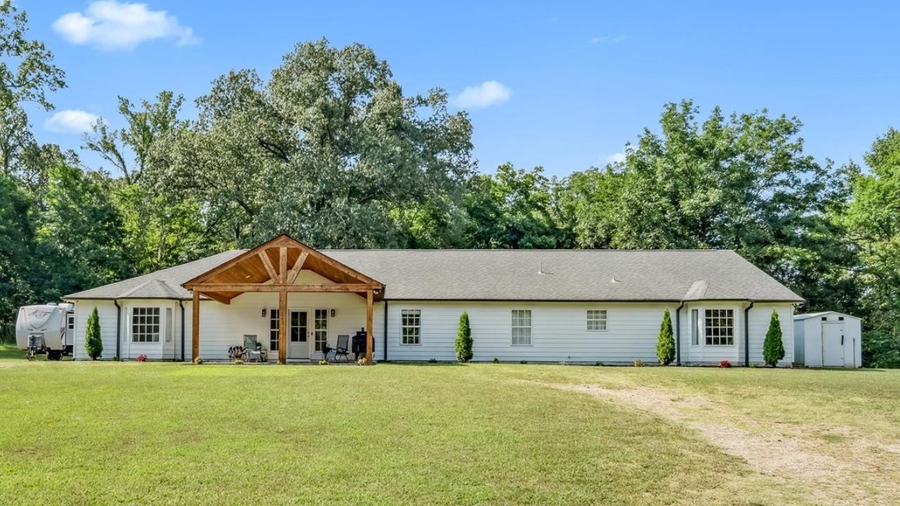 8159 Epperson Mill Road Millington, TN 38053 - Photo 29 of 31 a front view of a house with a garden
