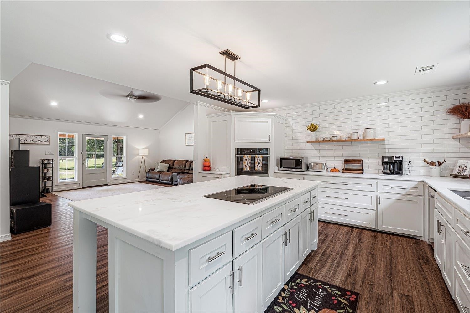 8159 Epperson Mill Road Millington, TN 38053 - Photo 9 of 31 a kitchen with a sink dishwasher a stove and white cabinets with wooden floor