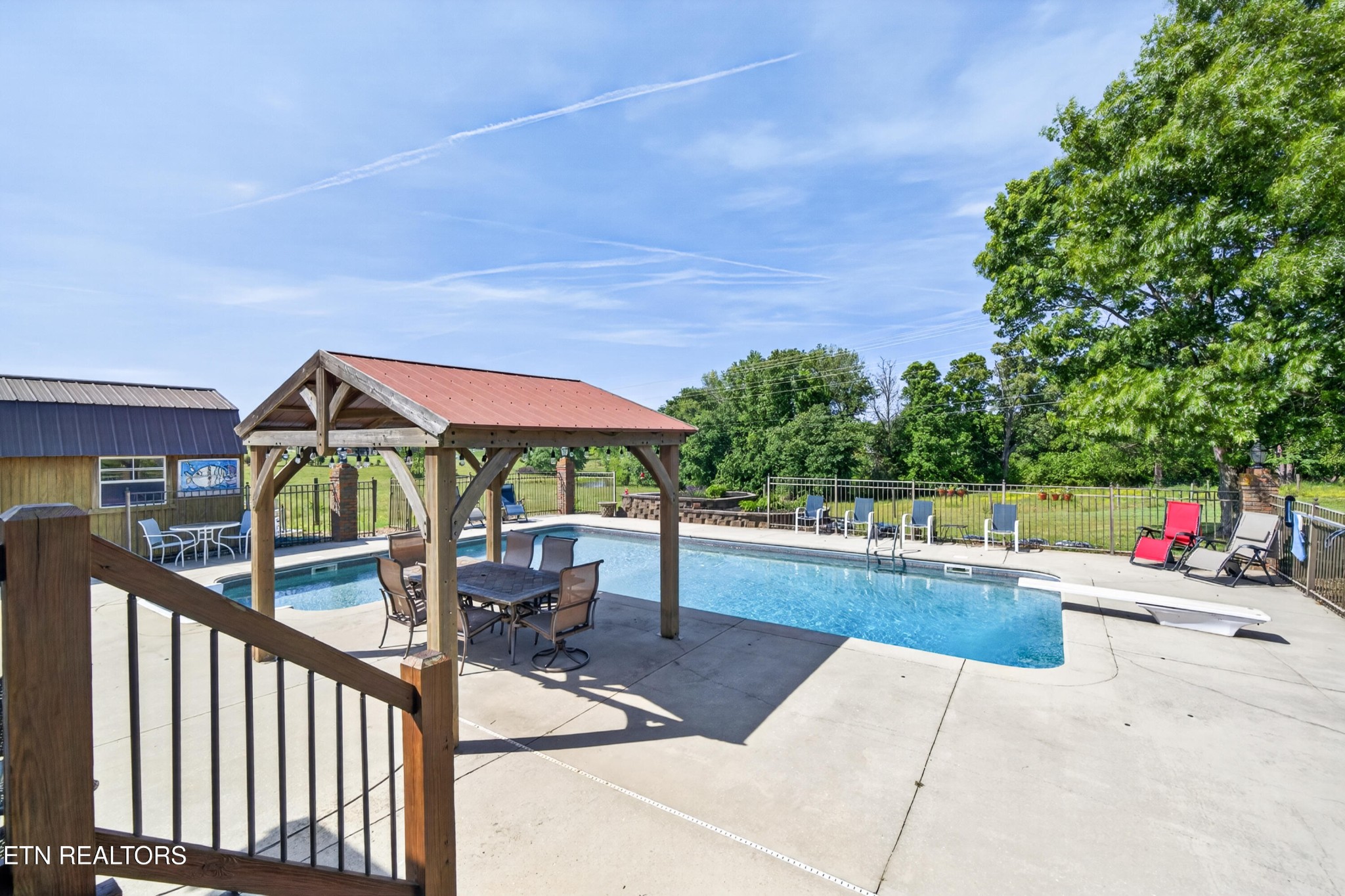 4015 Baxter Road Baxter, TN 38544 - Photo 35 of 48 a view of a patio with a table and chairs under an umbrella