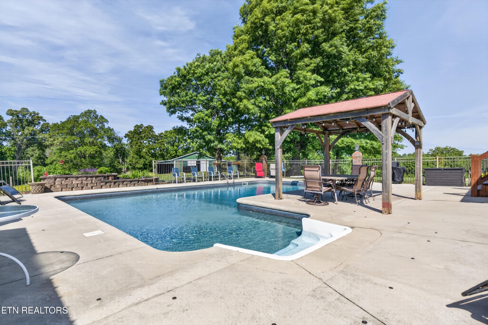 4015 Baxter Road Baxter, TN 38544 - Photo 36 of 48 a view of a swimming pool with chairs in patio