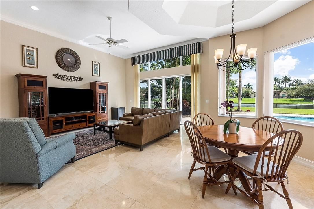 10324 Southwest 26th Street Davie, FL 33324 - Photo 11 of 37 a living room with furniture a large window and a flat screen tv