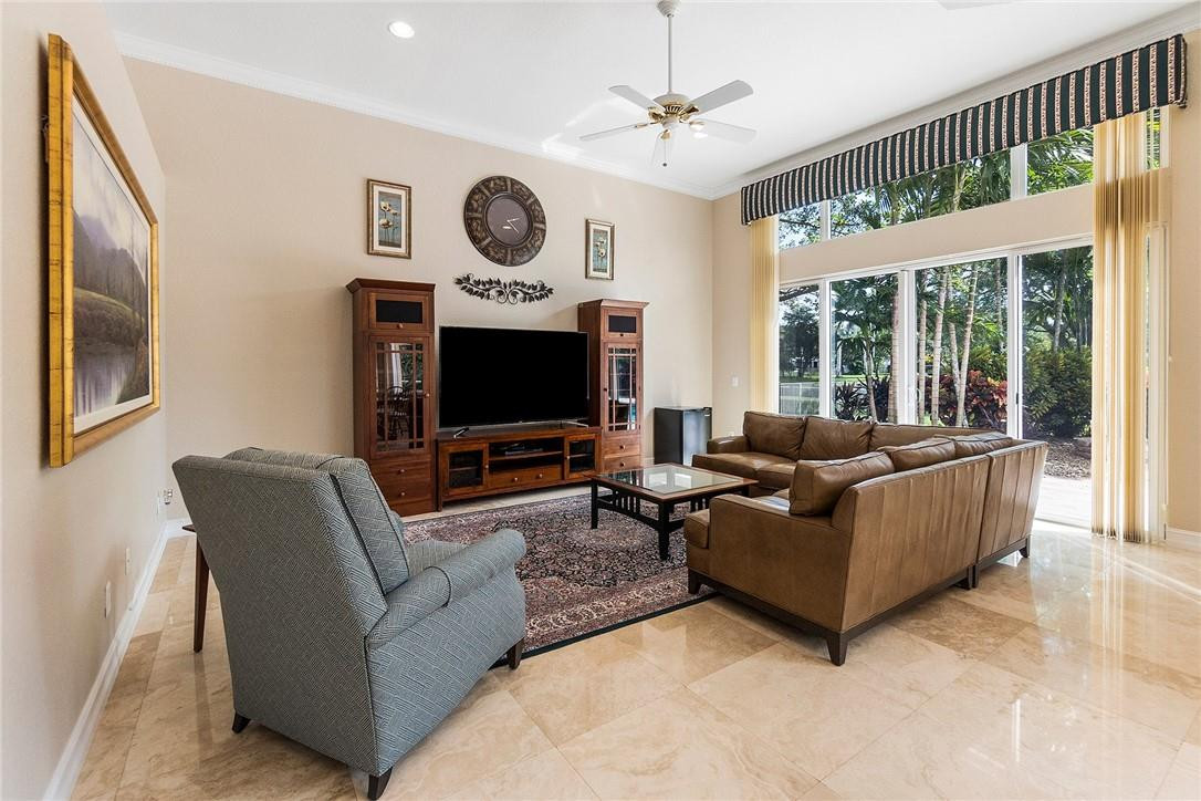 10324 Southwest 26th Street Davie, FL 33324 - Photo 13 of 37 a living room with furniture a large window and a flat screen tv