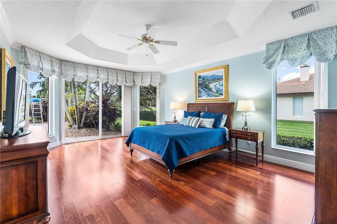 10324 Southwest 26th Street Davie, FL 33324 - Photo 14 of 37 a bedroom with a large bed and a chandelier