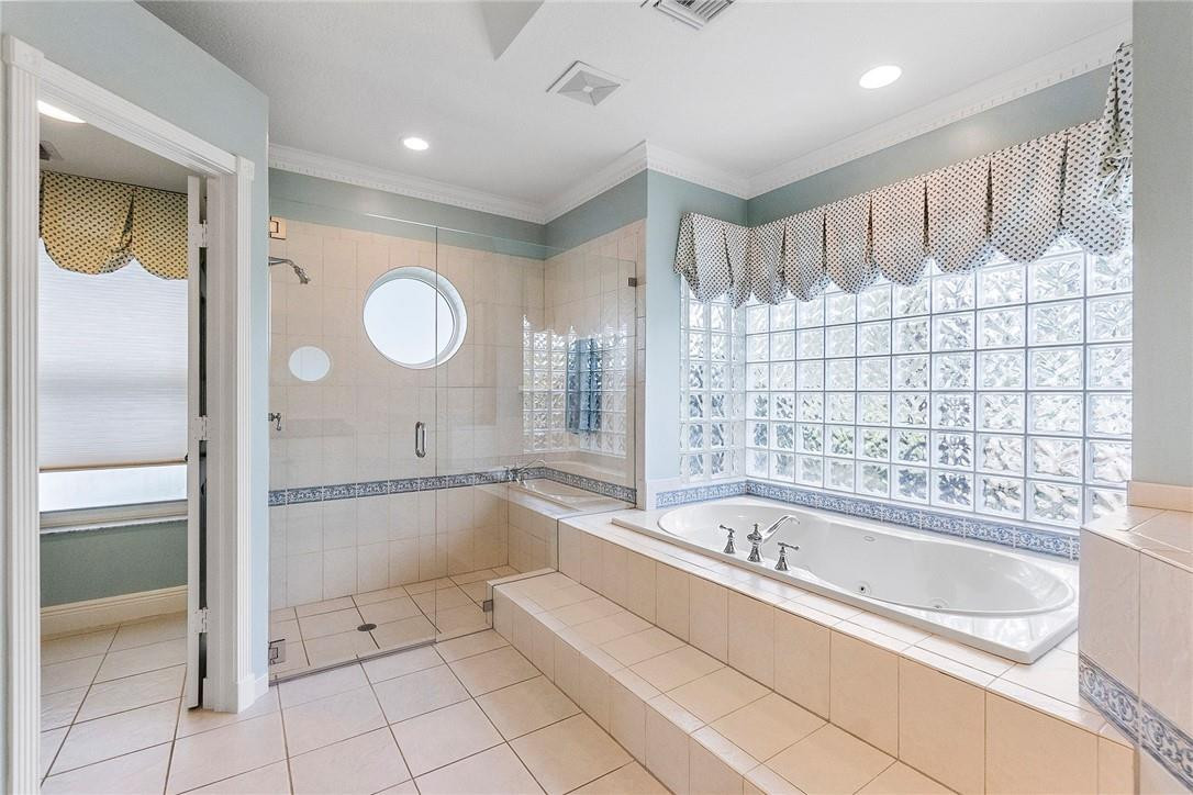 10324 Southwest 26th Street Davie, FL 33324 - Photo 18 of 37 a bathroom with a bathtub and a shower