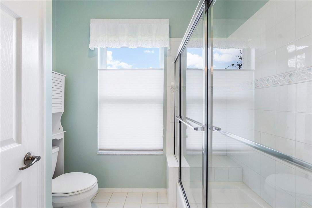 10324 Southwest 26th Street Davie, FL 33324 - Photo 21 of 37 a bathroom with a glass shower door