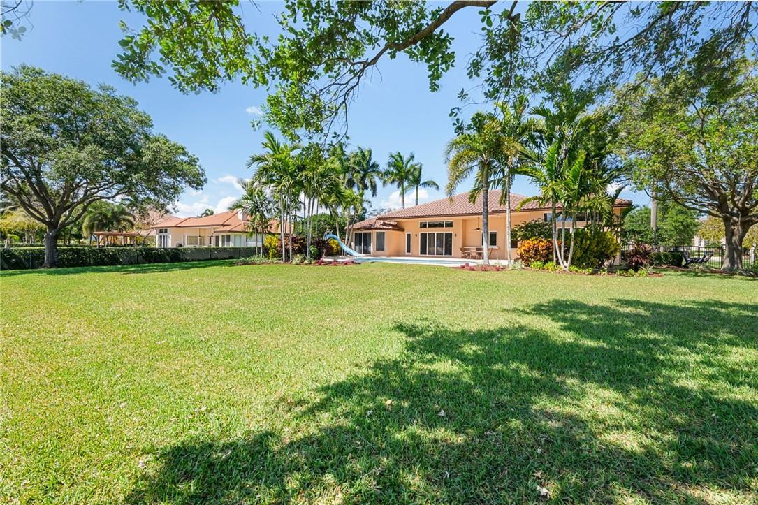 10324 Southwest 26th Street Davie, FL 33324 - Photo 31 of 37 a view of a house with a big yard and large trees