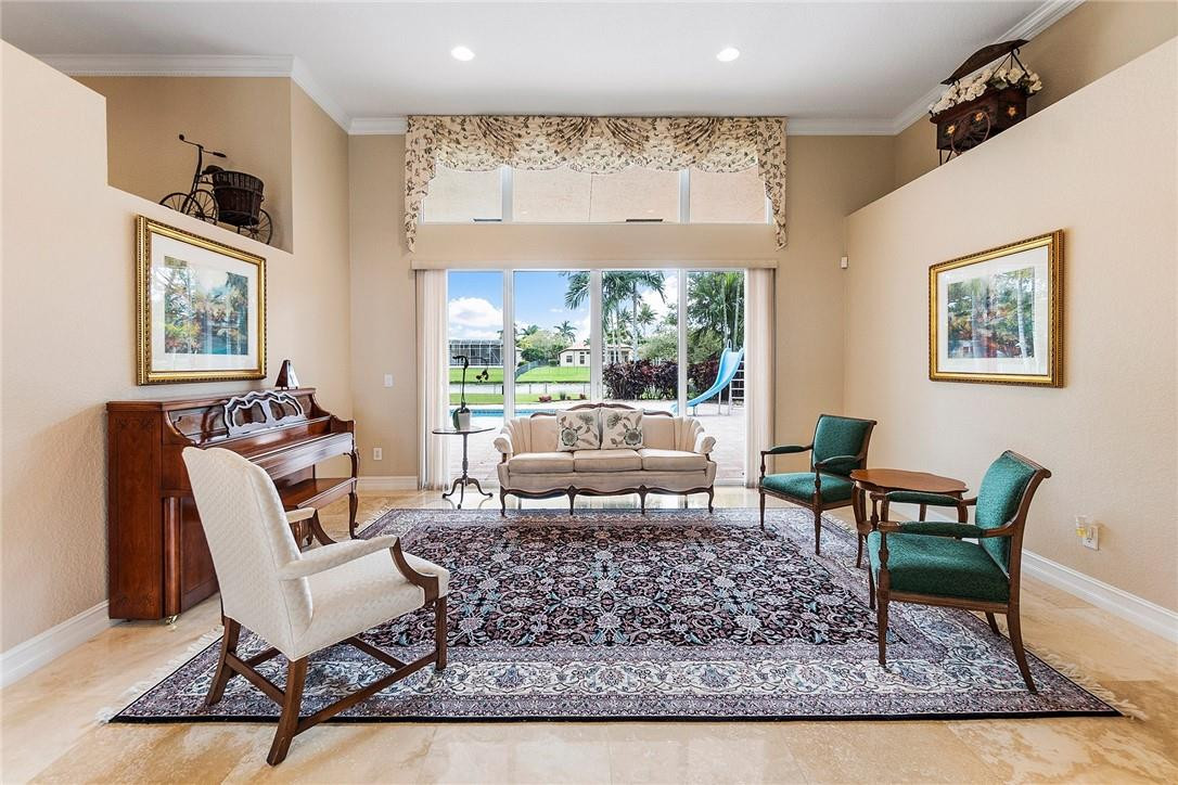 10324 Southwest 26th Street Davie, FL 33324 - Photo 8 of 37 a living room with furniture and a rug