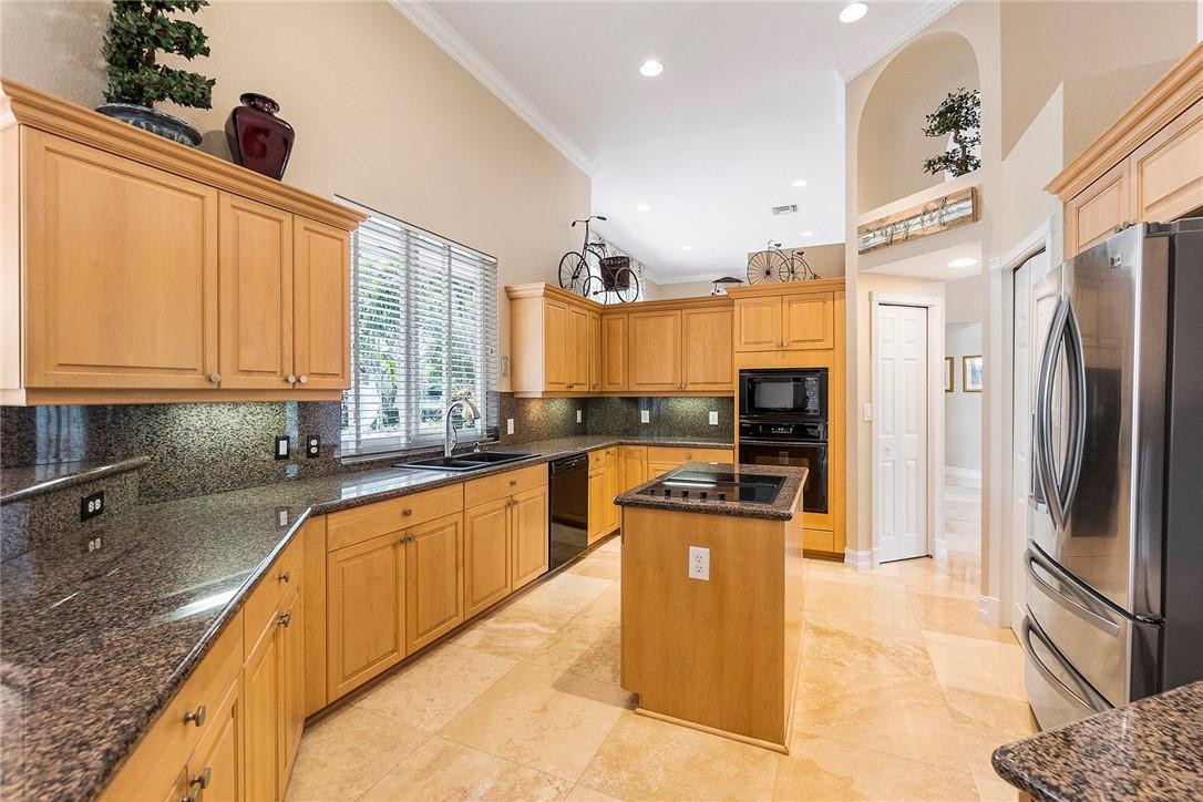 10324 Southwest 26th Street Davie, FL 33324 - Photo 9 of 37 a large kitchen with stainless steel appliances granite countertop a refrigerator a oven and a sink