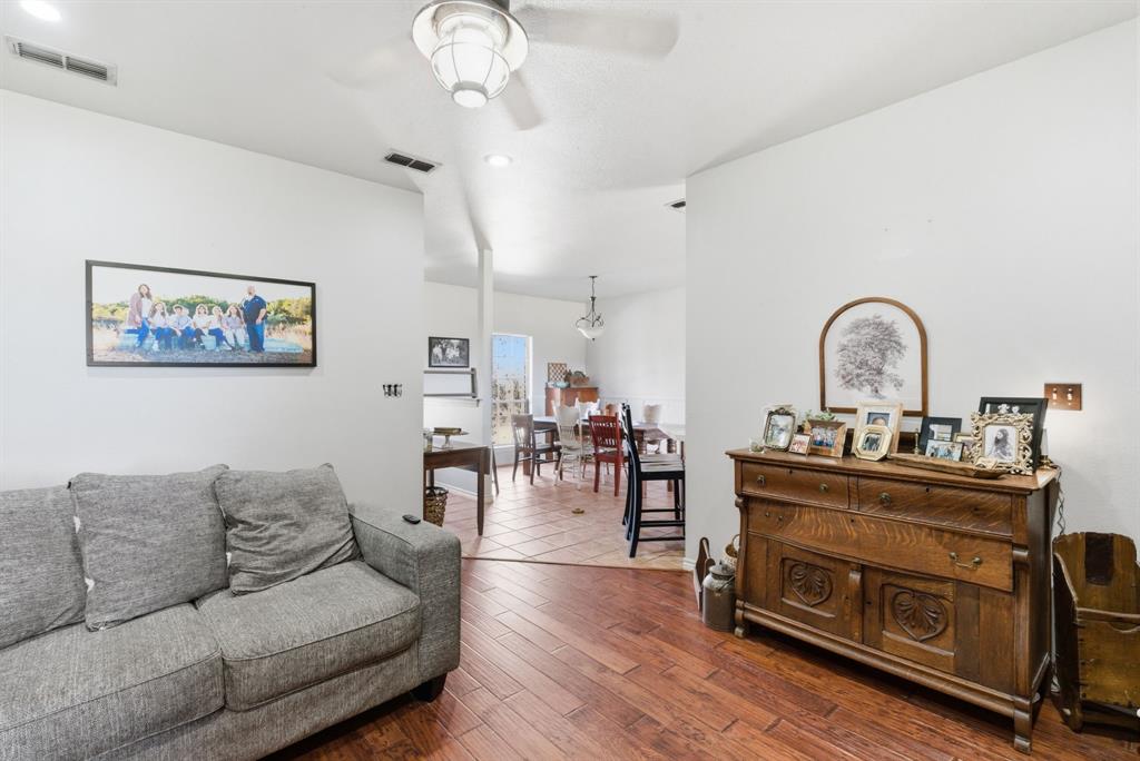 1889 Greenwood Road, Unit RES Weatherford, TX 76088 - Photo 4 of 11 a living room with furniture a dining table and a fireplace