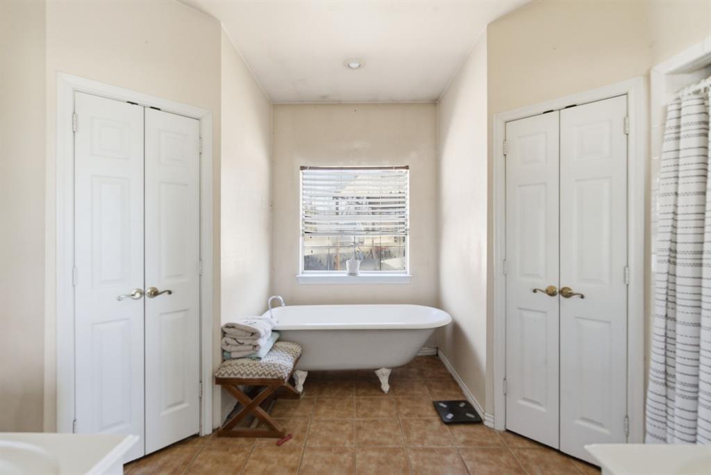 1889 Greenwood Road, Unit RES Weatherford, TX 76088 - Photo 9 of 11 a bedroom with a bed and a window