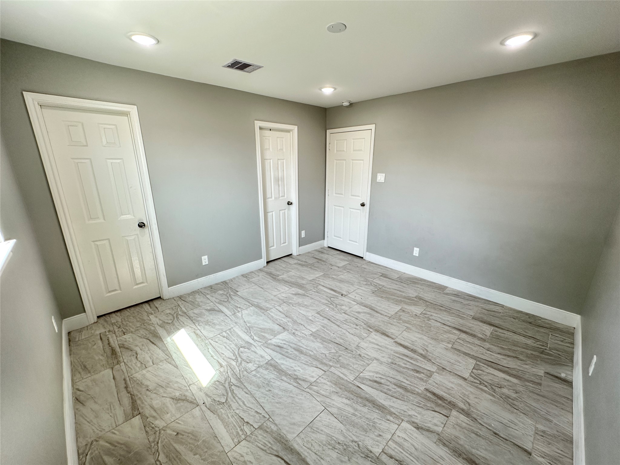 12703 West Hardy Road Houston, TX 77037 - Photo 12 of 29 an empty room with wooden floor and windows