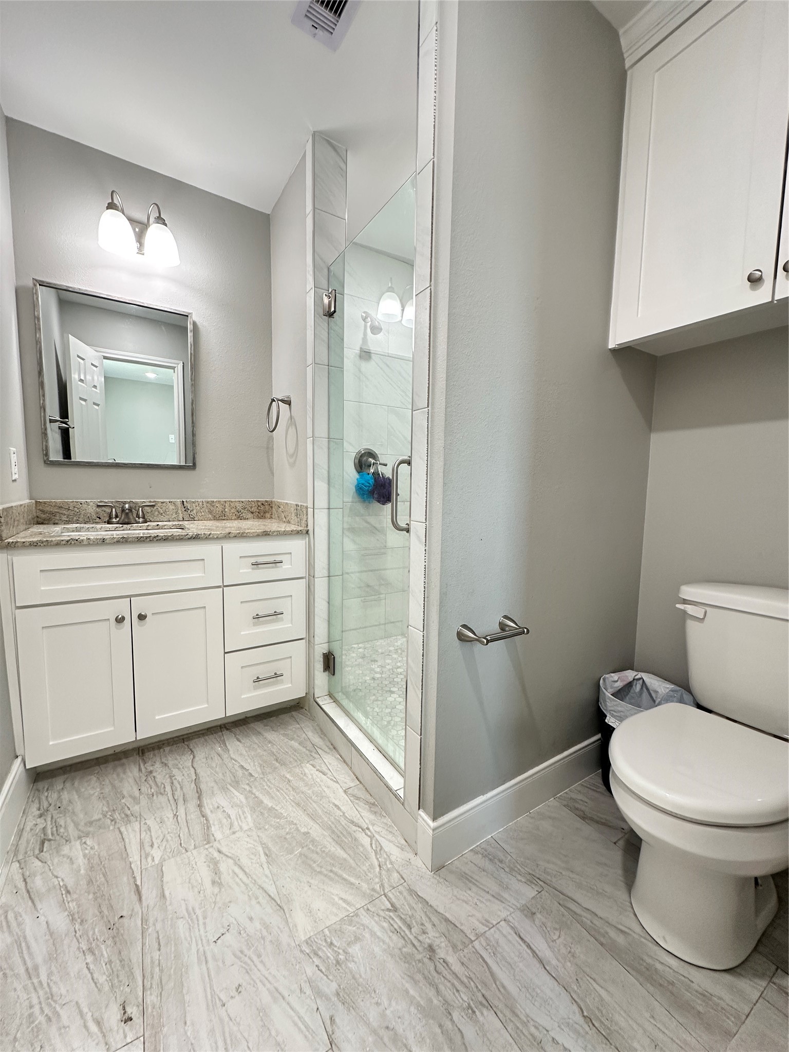 12703 West Hardy Road Houston, TX 77037 - Photo 13 of 29 a bathroom with a toilet sink and mirror