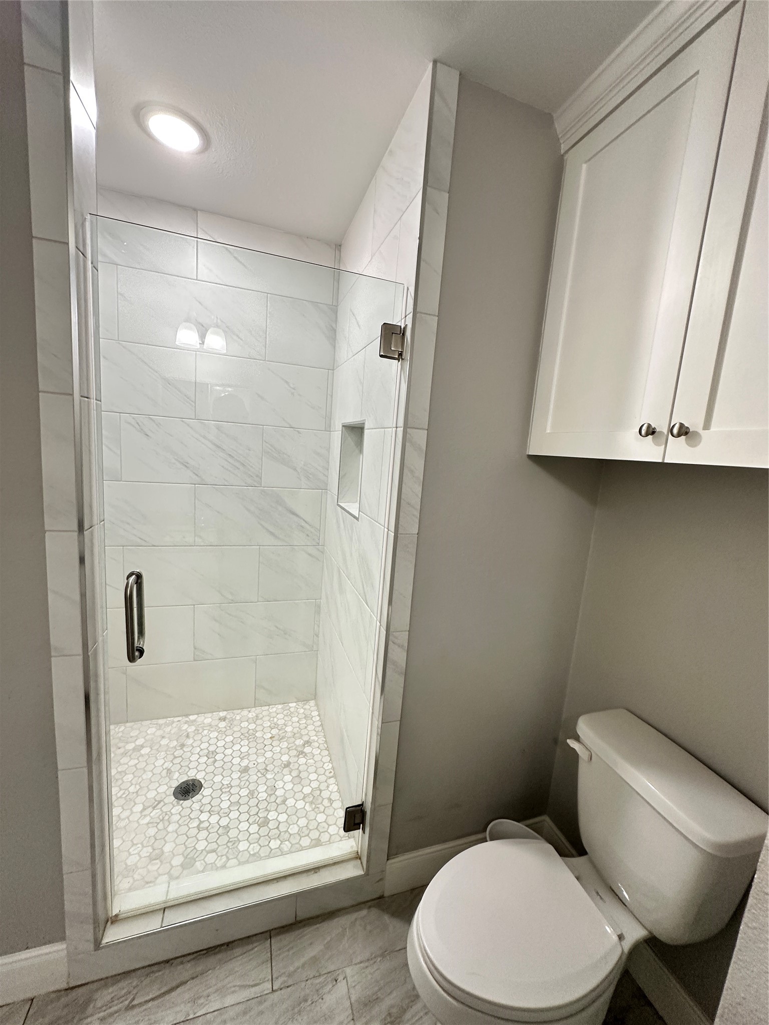 12703 West Hardy Road Houston, TX 77037 - Photo 16 of 29 a bathroom with a toilet and a shower