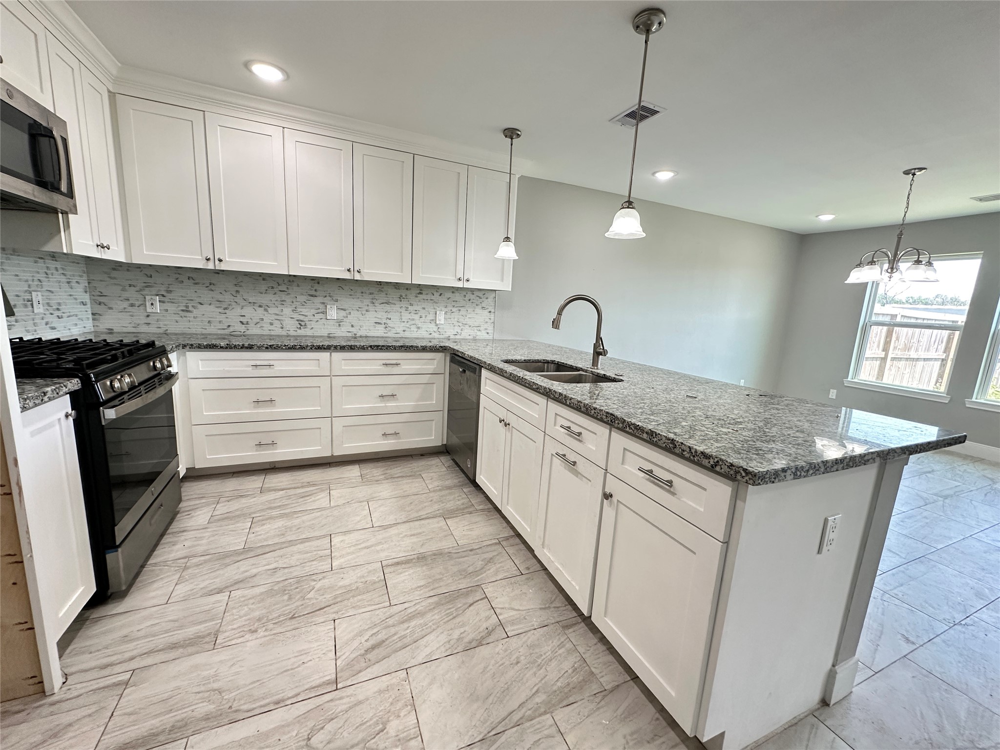 12703 West Hardy Road Houston, TX 77037 - Photo 8 of 29 a kitchen with granite countertop a sink and cabinets