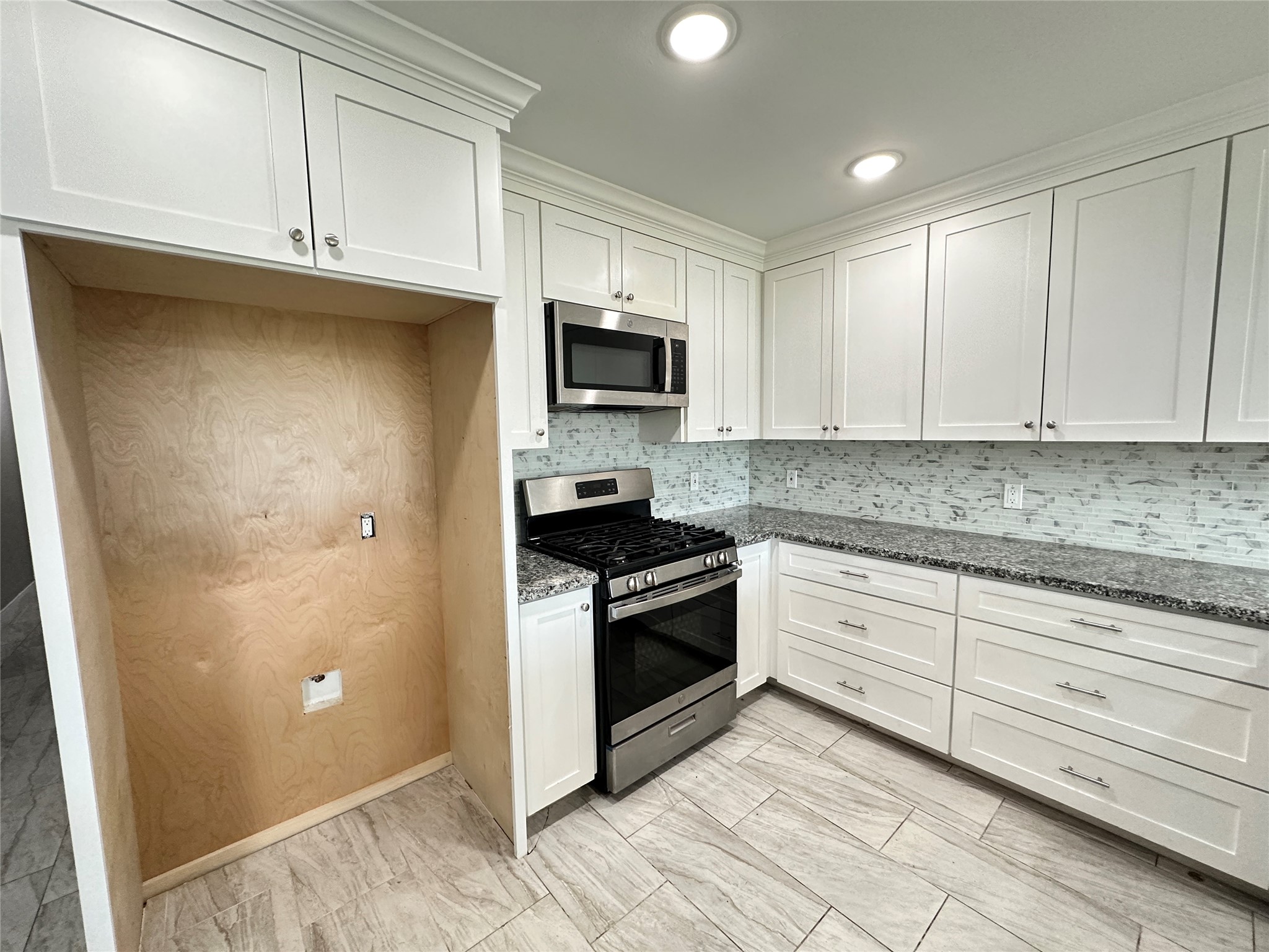 12703 West Hardy Road Houston, TX 77037 - Photo 9 of 29 a kitchen with granite countertop cabinets stainless steel appliances and a sink