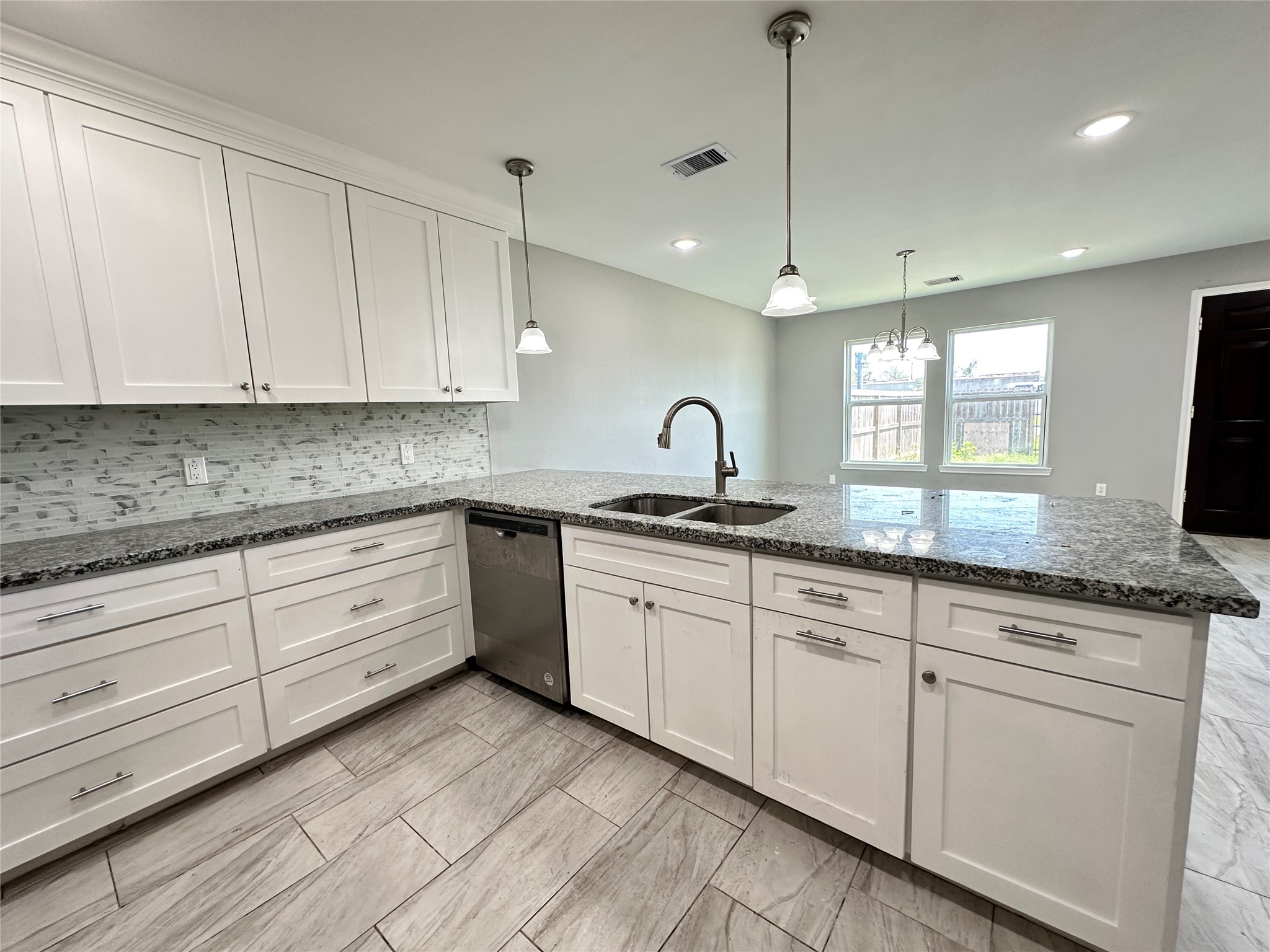 12703 West Hardy Road Houston, TX 77037 - Photo 10 of 29 a kitchen with granite countertop white cabinets white appliances and a sink