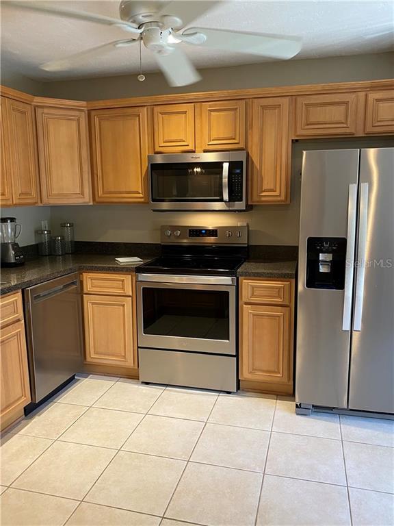 1667 Brookhouse Circle, Unit BR128 Sarasota, FL 34231 - Photo 11 of 38 a kitchen with stainless steel appliances granite countertop a stove a microwave and a sink
