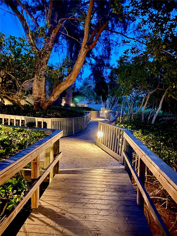 1667 Brookhouse Circle, Unit BR128 Sarasota, FL 34231 - Photo 17 of 38 a view of balcony with wooden floor and fence