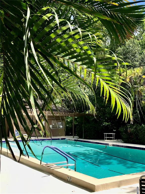 1667 Brookhouse Circle, Unit BR128 Sarasota, FL 34231 - Photo 19 of 38 a view of a backyard