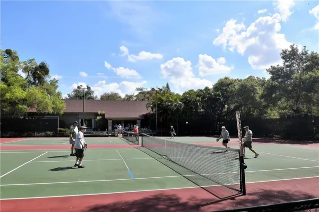 a basketball court with view of trees in the background
