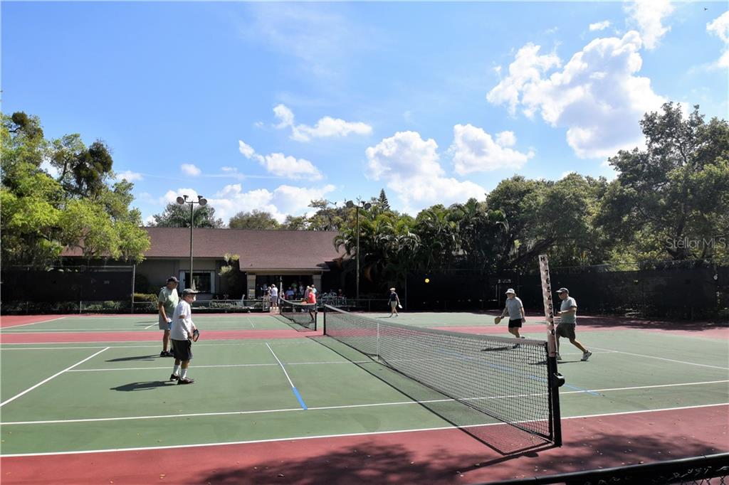 1667 Brookhouse Circle, Unit BR128 Sarasota, FL 34231 - Photo 32 of 38 a basketball court with view of trees in the background