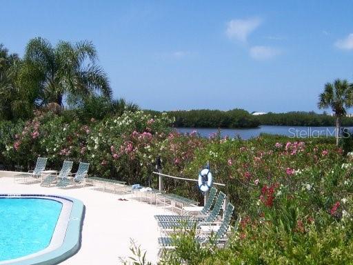 1667 Brookhouse Circle, Unit BR128 Sarasota, FL 34231 - Photo 35 of 38 a view of a swimming pool with a patio