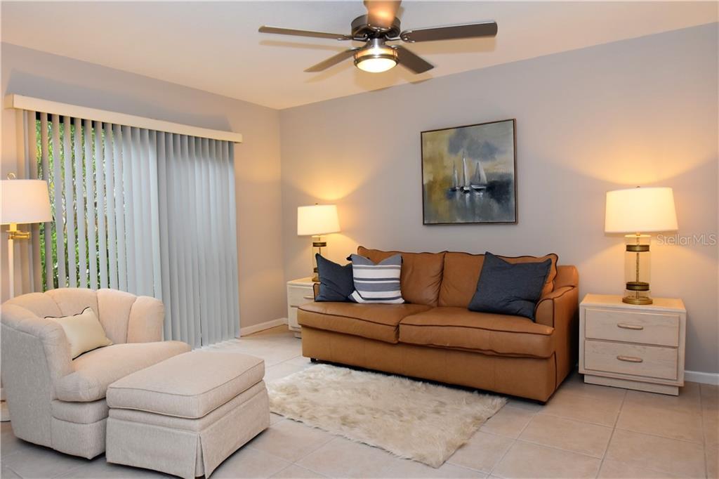 1667 Brookhouse Circle, Unit BR128 Sarasota, FL 34231 - Photo 5 of 38 a living room with furniture and a window