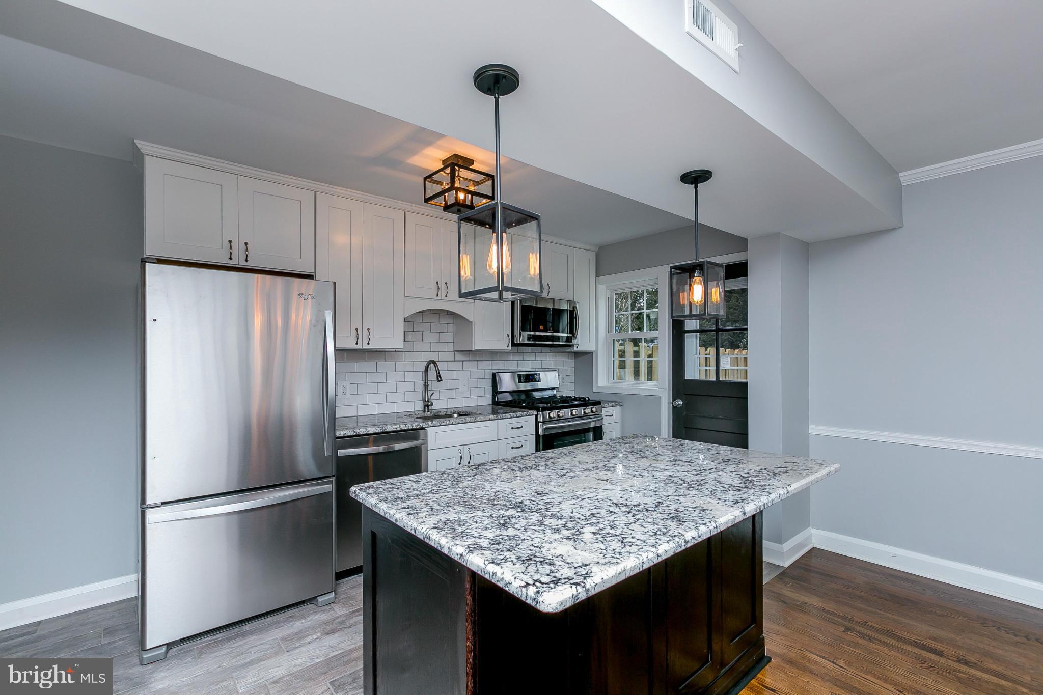 7126 Heathfield Road Baltimore, MD 21212 - Photo 5 of 23 a kitchen with kitchen island a counter space and refrigerator